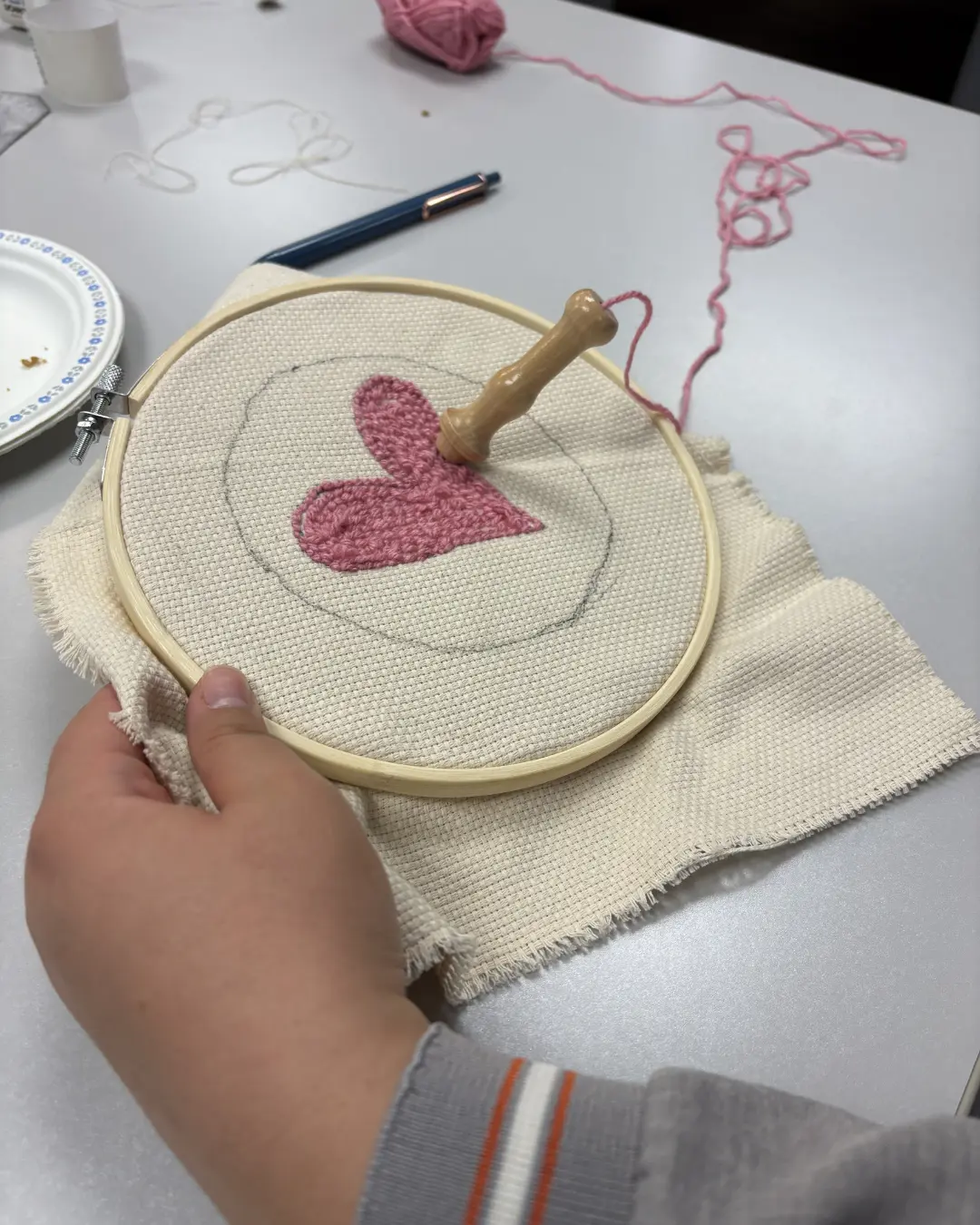 Participants creating punch knitting art pieces at the Threads of Peace workshop at Kitchener Public Library as part of United in Voices preparations.