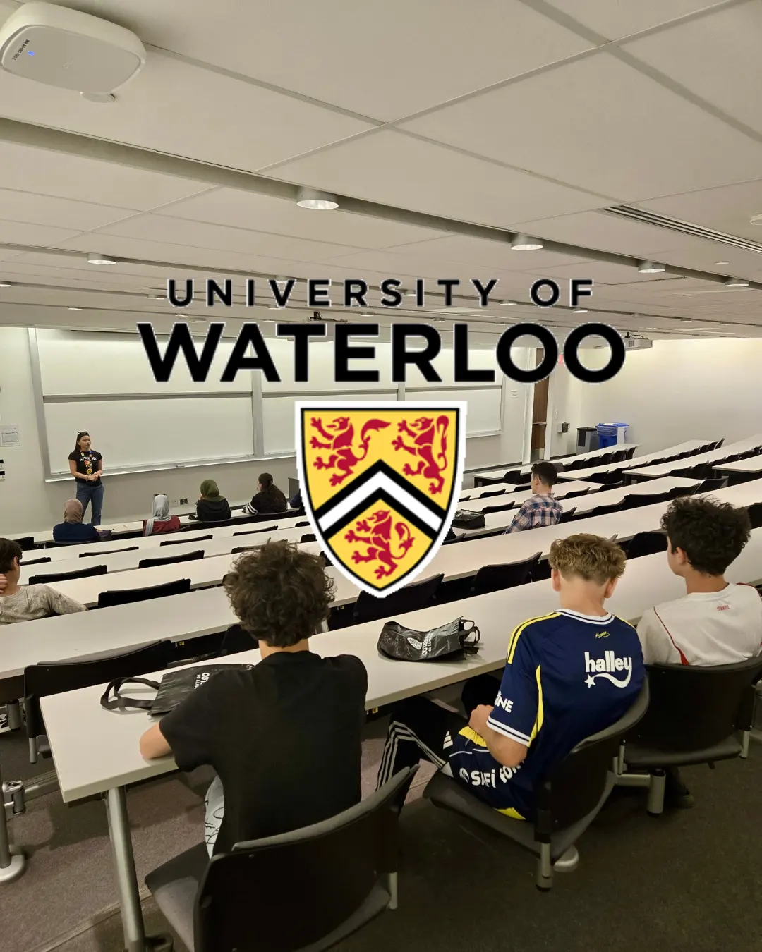 GRFS mentorship students attending an educational presentation in a University of Waterloo lecture hall.