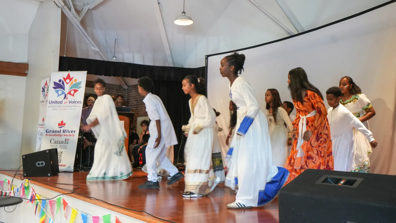 United in Voices Intercultural Dialogue Festival participants, performers, community booths, and cultural activities at Victoria Park hosted by Grand River Friendship Society.