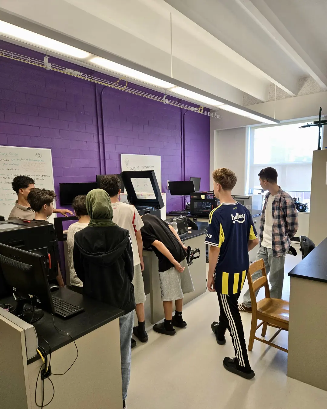 GRFS mentorship students exploring equipment in a University of Waterloo engineering laboratory.