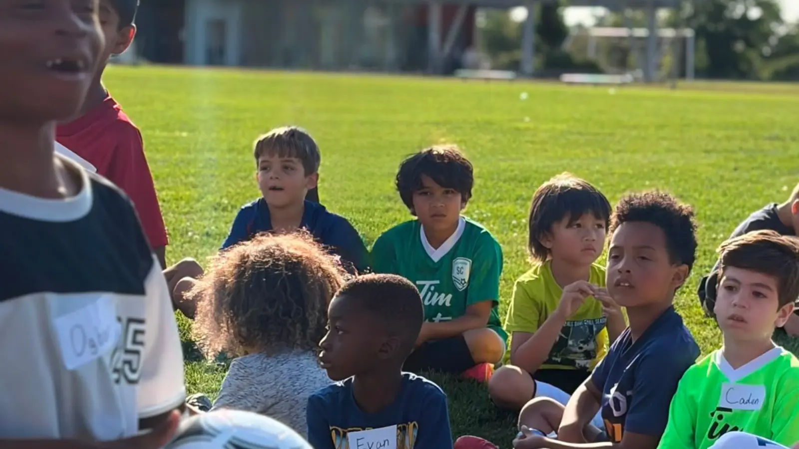 Young soccer participants listening to instructions during the GRFS Football for Learning program.