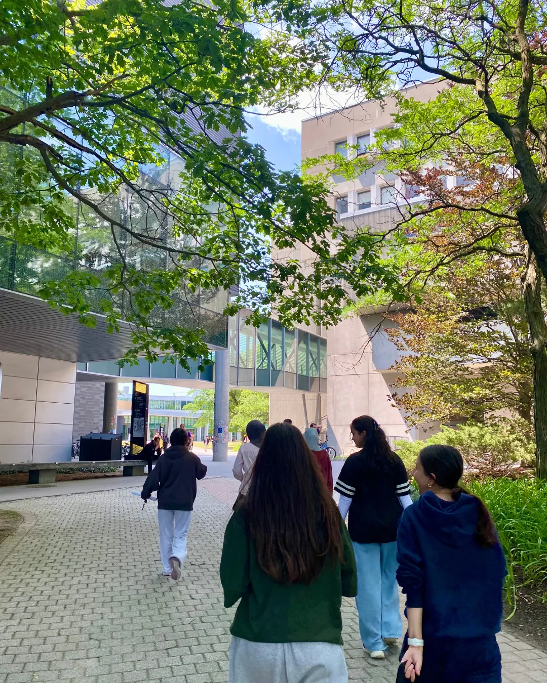 GRFS mentorship students walking between academic buildings on the University of Waterloo campus.