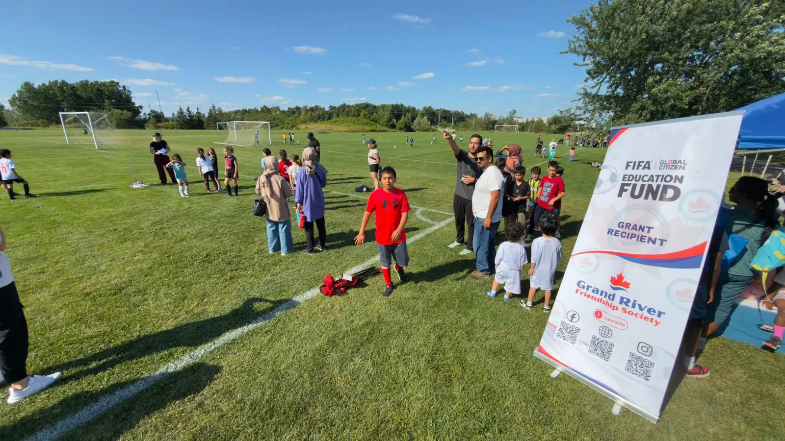 GRFS summer soccer field beside a FIFA Global Citizen Education Fund grant recipient banner.