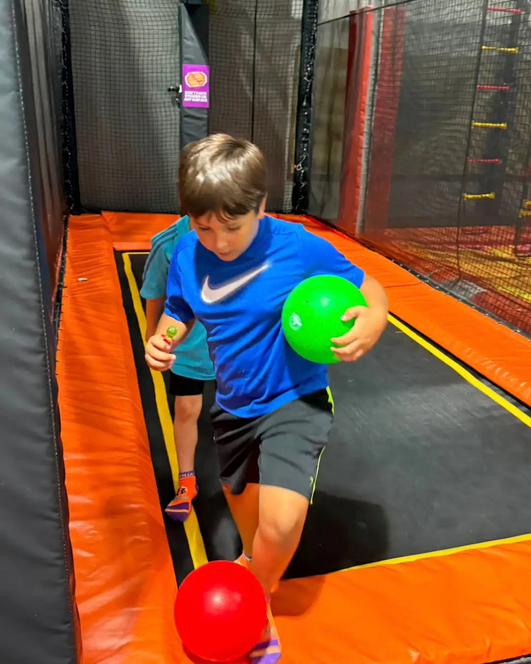 Children playing with balls on an indoor trampoline court at GRFS Summer School 2026