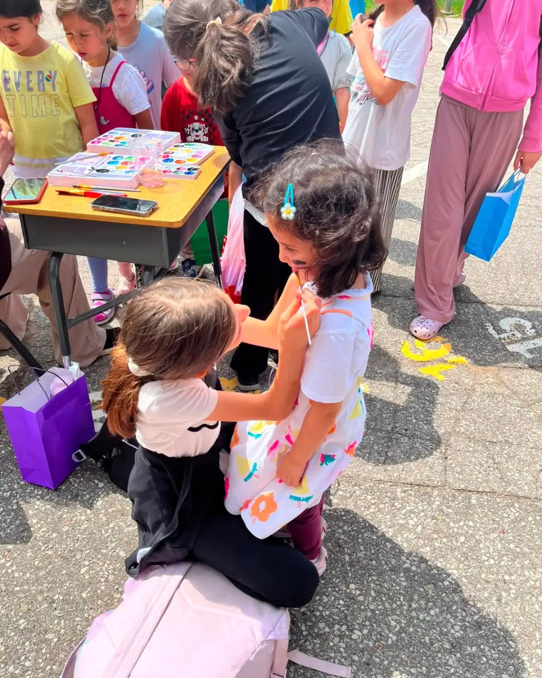 Children taking part in an outdoor face-painting activity at GRFS Summer School 2026