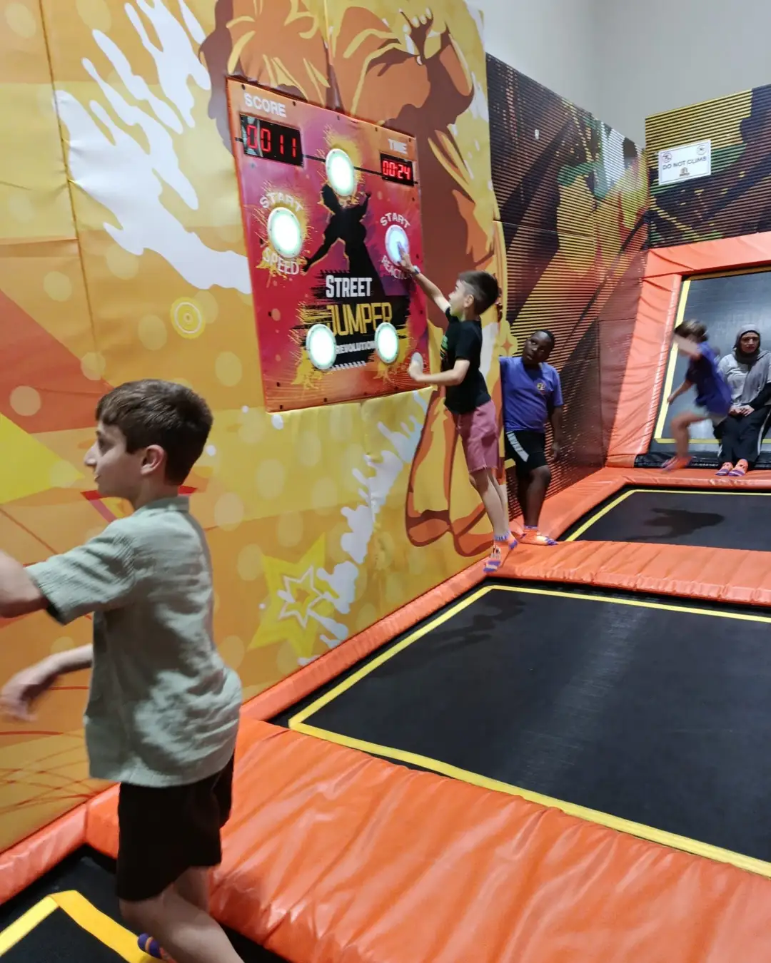 Children trying an interactive reaction game at an indoor play venue at GRFS Summer School 2026