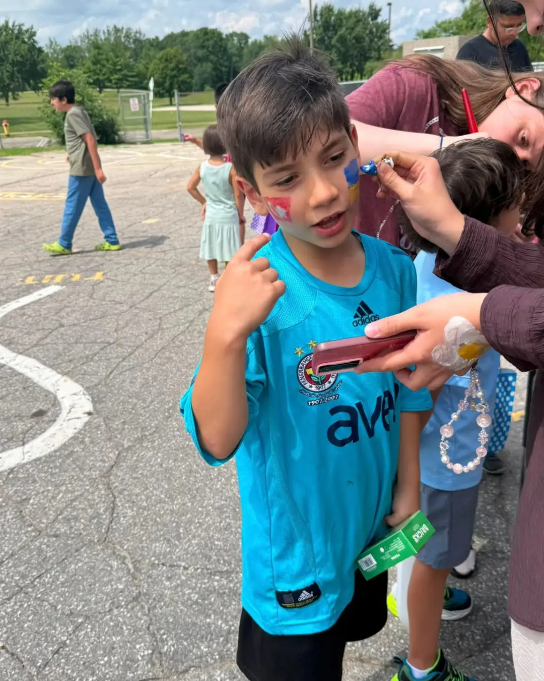 A child having his face painted during an outdoor activity at GRFS Summer School 2026