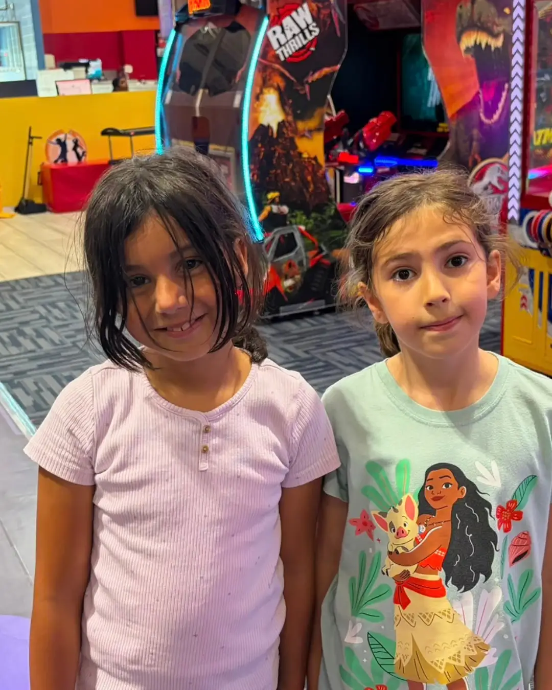 Two children standing together at an indoor recreation venue at GRFS Summer School 2026