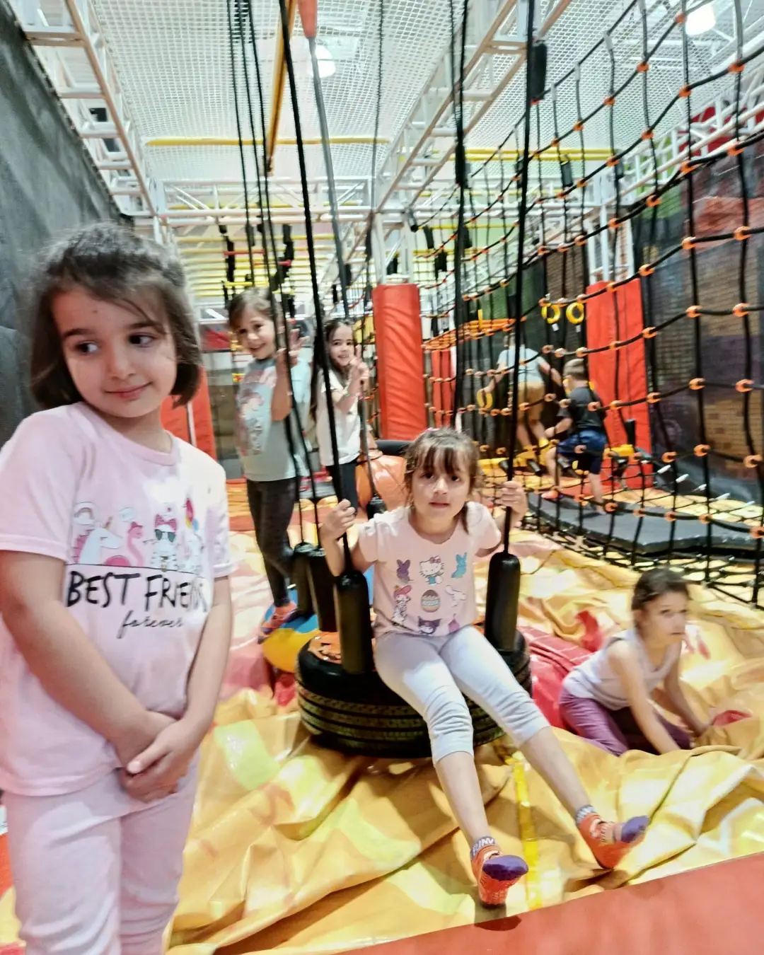 Children exploring a tyre swing and ropes obstacle course at GRFS Summer School 2026