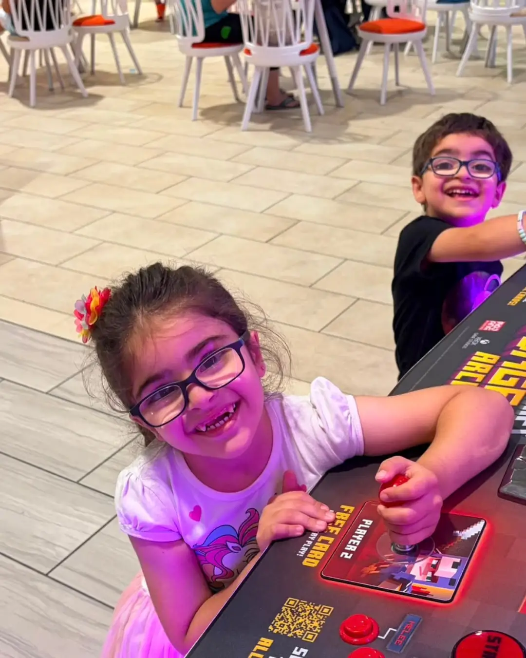 Children enjoying an arcade game together at GRFS Summer School 2026