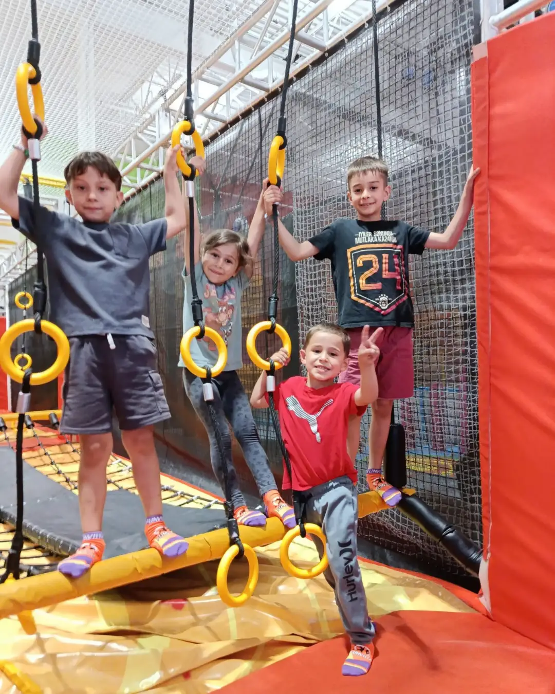 Children exploring an indoor ropes and rings obstacle course at GRFS Summer School 2026