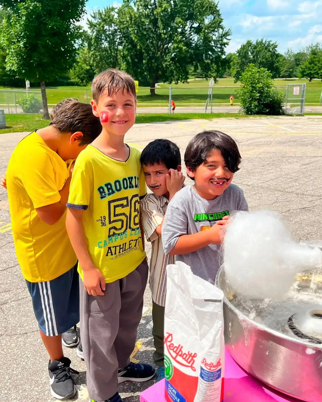 Children watching cotton candy being made outdoors at GRFS Summer School 2026