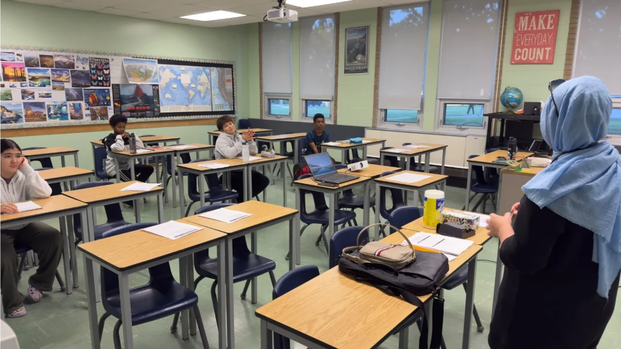 An instructor leading a classroom session with students seated at desks during GRFS academic support.
